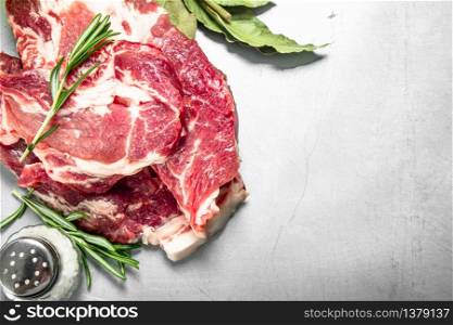 Fresh raw beef meat with spices and herbs. On rustic background.. Fresh raw beef meat with spices and herbs.