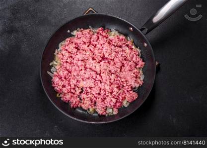 Fresh raw beef mince with onions in a pan. Cooking tasty healthy food. Fresh raw beef mince with onions in a pan