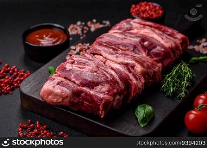 Fresh raw beef ribs with salt, spices and herbs prepared for grilling