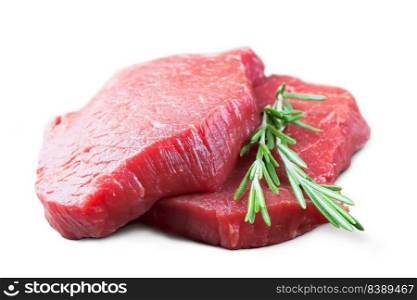 Fresh raw beef steak with rosemary isolated over white background. Fresh raw beef steak with rosemary