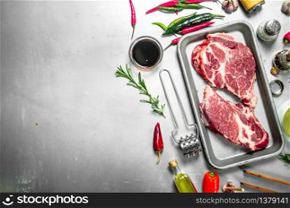 Fresh raw beef steak with spices. On rustic background.. Fresh raw beef steak with spices.