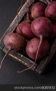 Fresh raw beetroot in the form of tubers on a textured concrete background. Vegetarian Ingredients. Fresh raw beetroot in the form of tubers on a textured concrete background