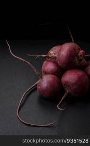 Fresh raw beetroot in the form of tubers on a textured concrete background. Vegetarian Ingredients. Fresh raw beetroot in the form of tubers on a textured concrete background