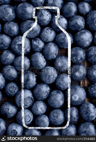Fresh raw blueberries with smothie bottle shape on white background