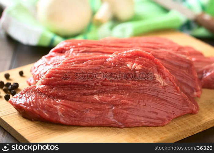 Fresh raw boneless beef meat cut in slices, photographed with natural light (Selective Focus, Focus in the middle of the slice)