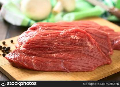 Fresh raw boneless beef meat cut in slices, photographed with natural light (Selective Focus, Focus in the middle of the slice)