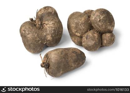 Fresh raw brown organic yams, tropical food isolated on white background