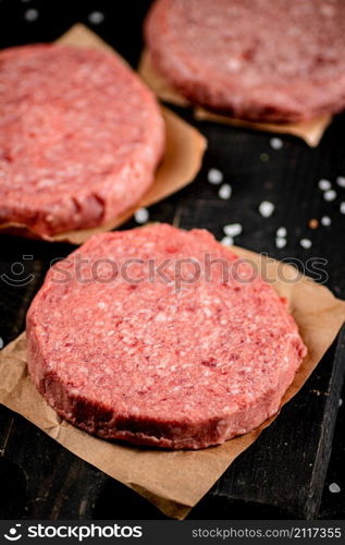 Fresh raw burger on the table. Macro background. High quality photo. Fresh raw burger on the table.