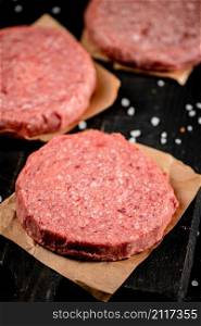Fresh raw burger on the table. Macro background. High quality photo. Fresh raw burger on the table.