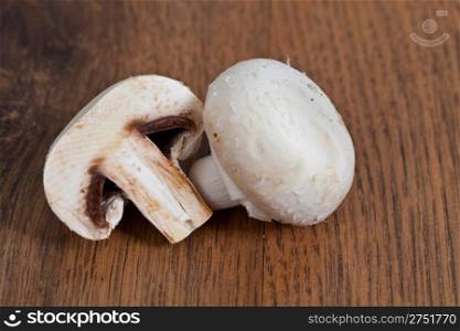 Fresh raw champignon mushrooms on wooden background