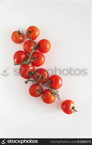 Fresh raw cherry tomatoes on white tabble. Top view
