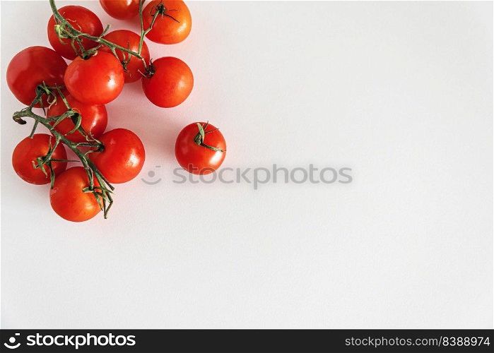 Fresh raw cherry tomatoes on white tabble. Top view