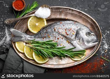 Fresh raw dorado fish with ingredients for cooking. Top view