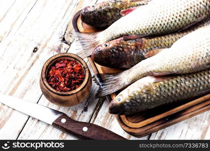 Fresh raw fish on wooden cutting board.Raw fish with spices for cooking. Raw fish with spices