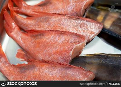 Fresh raw greenling fish and sea bass fish in the supermarket. Fresh raw greenling fish and sea bass fish