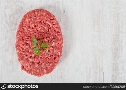 Fresh raw hamburger meat on wooden background