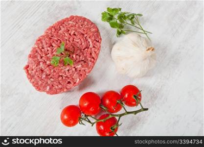 Fresh raw hamburger meat on wooden background