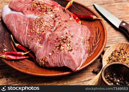 Fresh raw meat on old wooden table.Food preparation.. Raw meat with spices