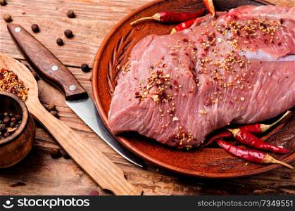 Fresh raw meat on old wooden table. Raw meat with spices