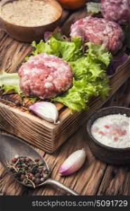 fresh raw minced meat beef. raw minced meat and lettuce on rustic wooden background