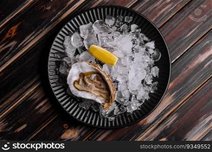 Fresh raw open oyster with ice and lemon slices