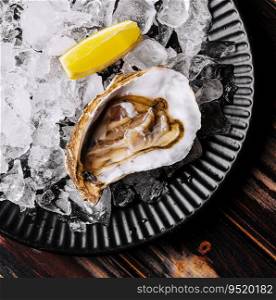 Fresh raw open oyster with ice and lemon slices