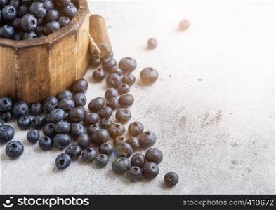 Fresh raw organic blueberries in vintage wooden box on kitchen background.