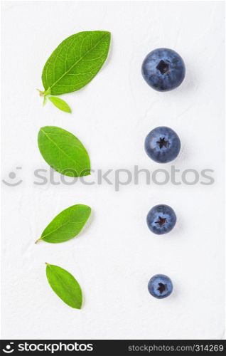 Fresh raw organic blueberries with leaf on white background.