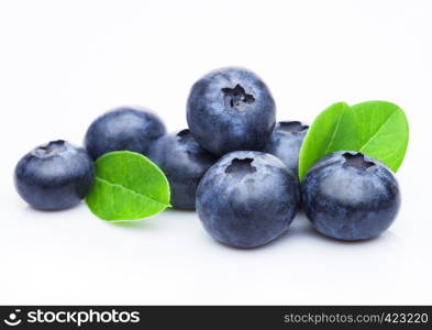 Fresh raw organic blueberries with leaf on white background.