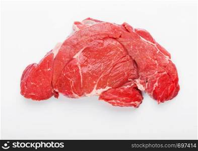 Fresh raw organic slice of braising steak fillet on white.