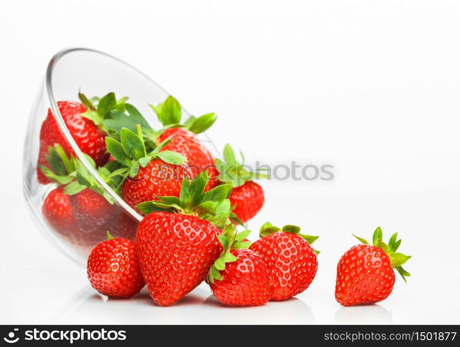 Fresh raw organic strawberries in glass bowl plate on white background. Macro