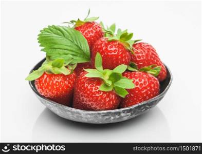 Fresh raw organic strawberries in steelbowl plate on white background. Best summer berries. Top view