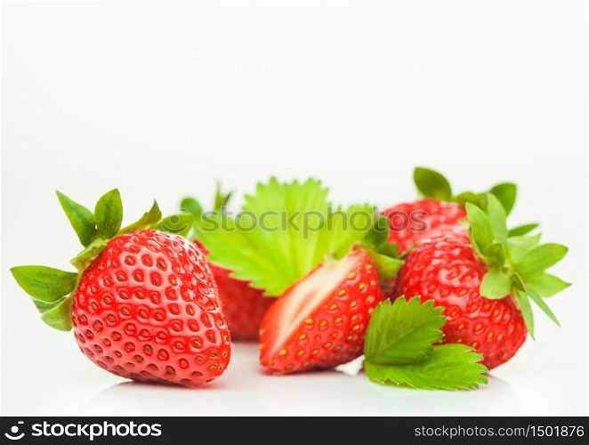 Fresh raw organic strawberries with leaf on white background. Macro