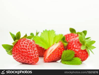 Fresh raw organic strawberries with leaf on white background. Macro