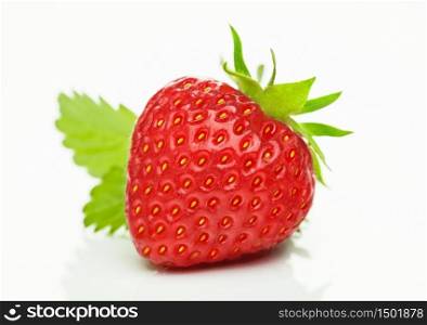 Fresh raw organic strawberry with leaf on white background with reflection.