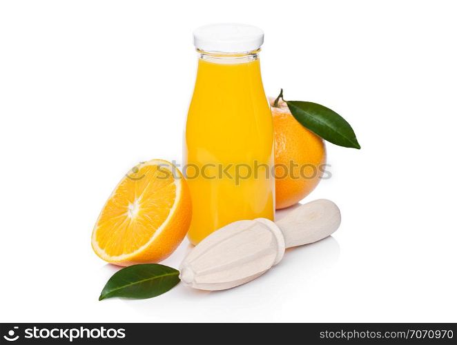 Fresh raw peeled oranges with hand wooden juice squeezer and glass bottle with leaves on white background
