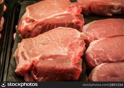 fresh raw pork chops at the butcher