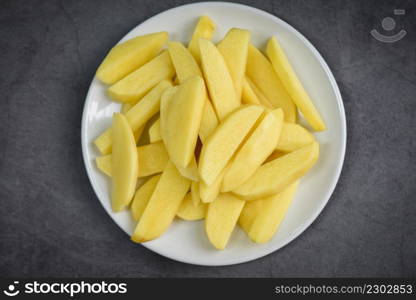 fresh raw potato wedges, chopped potatoes for cooked food on white plate