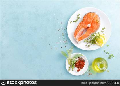 Fresh raw salmon fish steak with ingredients for cooking