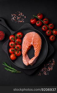 Fresh raw salmon steak with spices and herbs prepared for grilled baking. Healthy seafood food