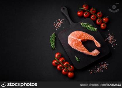 Fresh raw salmon steak with spices and herbs prepared for grilled baking. Healthy seafood food