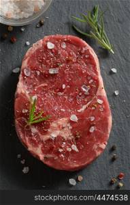 Fresh raw steak with salt and pepper