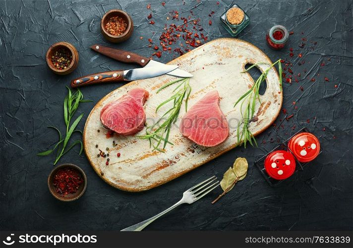 Fresh raw tuna steak on kitchen board. Raw tuna fish