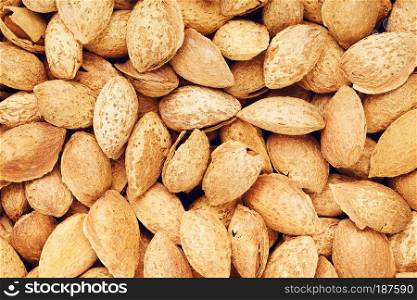 fresh raw unpeeled almonds nuts, food background. Unpeeled Almonds Nuts Background