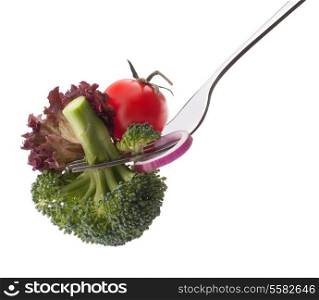 Fresh raw vegetables on fork isolated on white background cutout. Healthy eating concept.
