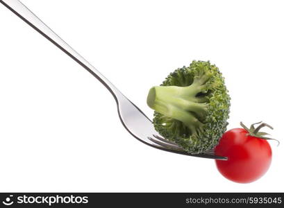 Fresh raw vegetables on fork isolated on white background cutout. Healthy eating concept.