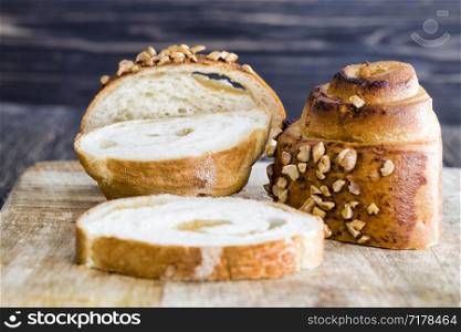 fresh real bun with peanut sprinkles, close-up of home-made delicious pastries, bun with filling cut into several pieces. fresh real bun