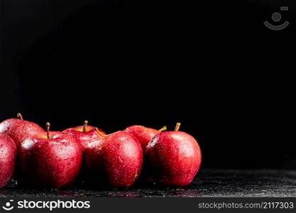 Fresh red apples on the table. On a black background. High quality photo. Fresh red apples on the table.