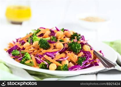 Fresh red cabbage, chickpea, carrot and broccoli salad on plate, photographed with natural light (Selective Focus, Focus in the middle of the image). Red Cabbage, Chickpea, Carrot and Broccoli Salad