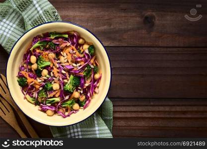 Fresh red cabbage, chickpea, carrot and broccoli salad with sunflower seeds in bowl, photographed overhead with natural light (Selective Focus, Focus on the salad). Red Cabbage, Chickpea, Carrot and Broccoli Salad